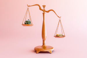 Scales with a cabbage on the left and a bagel on the right with a pink background